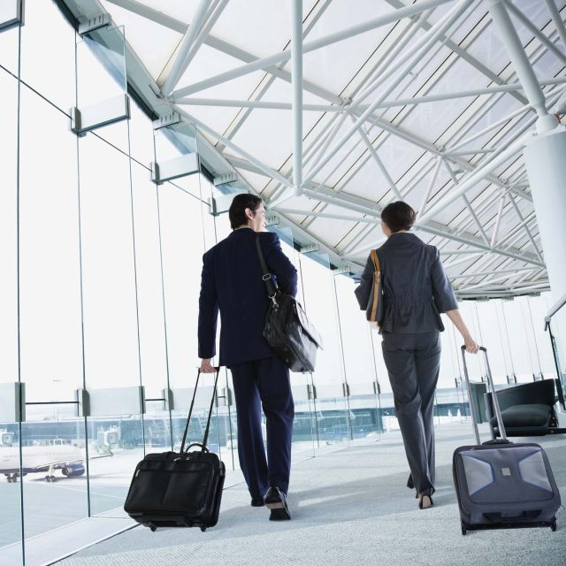 Multi-ethnic business people walking in airport