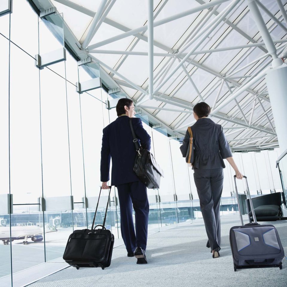 Multi-ethnic business people walking in airport